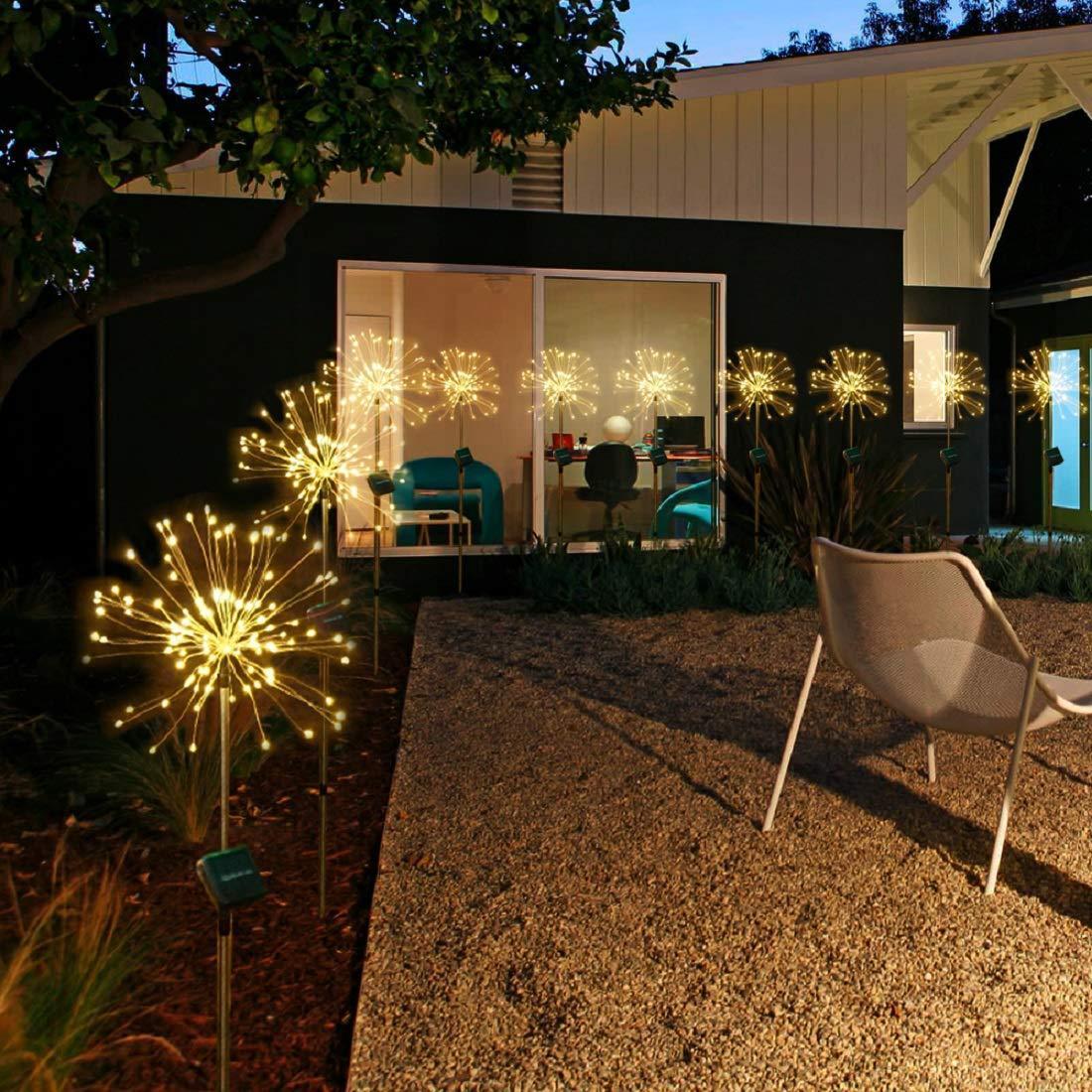 Solar Fireworks LED Lights illuminating a garden at night with a warm glow.